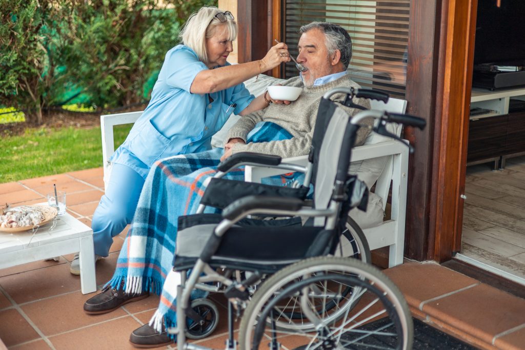 in-home care Brisbane - nurse feeding a participant